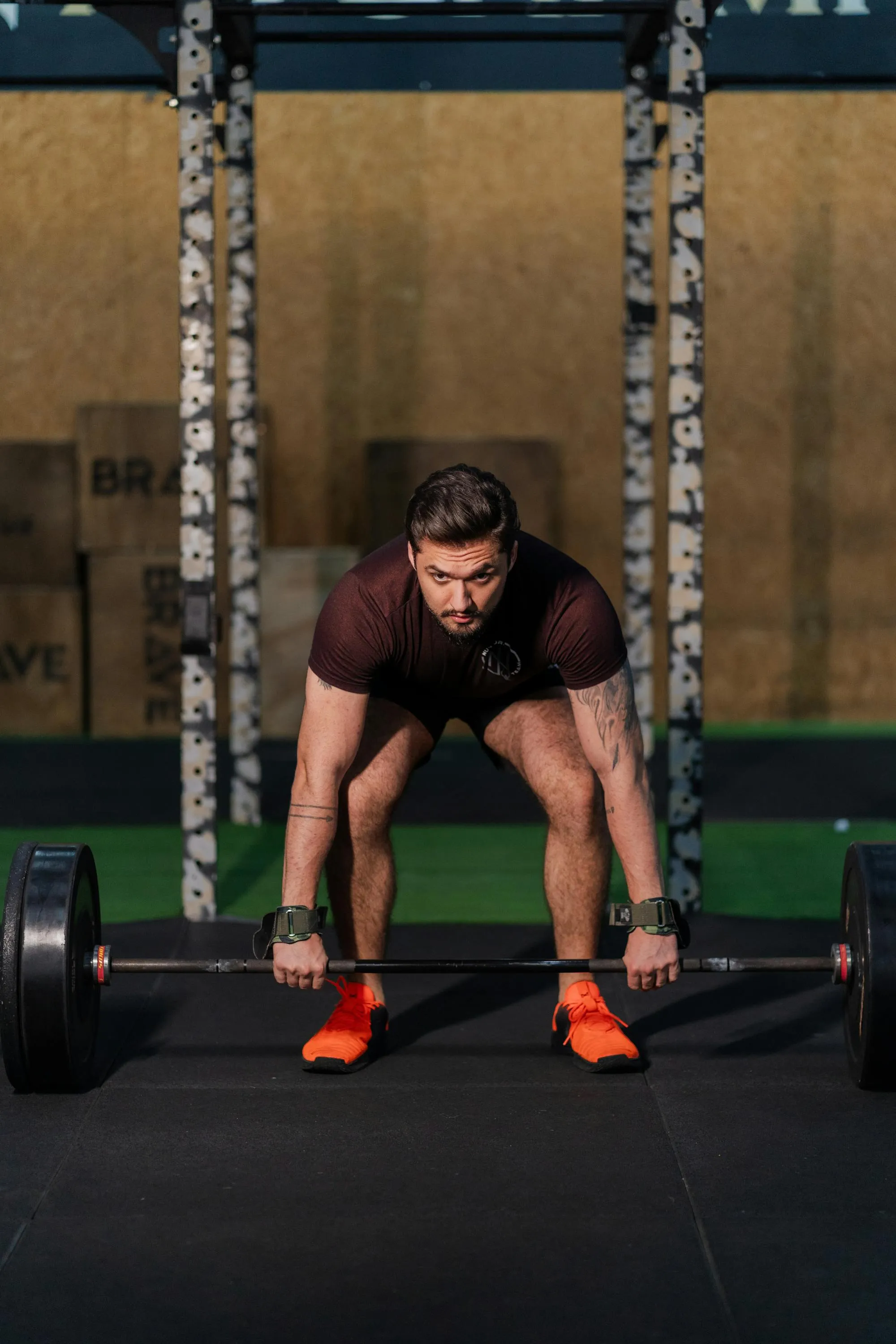 Strength athlete preparing to lift barbell in gym